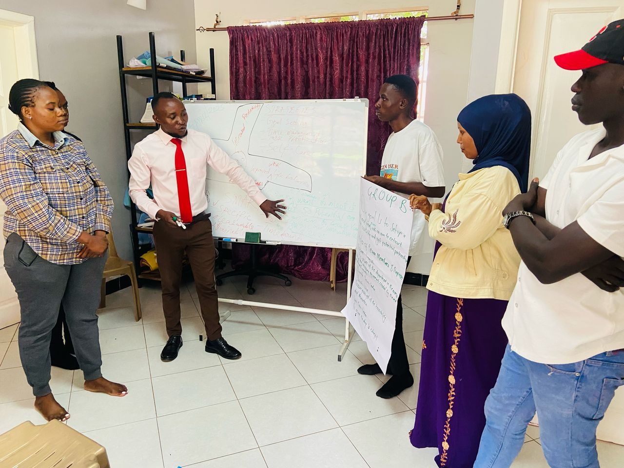 A scholar presenting ideas on a flipchart