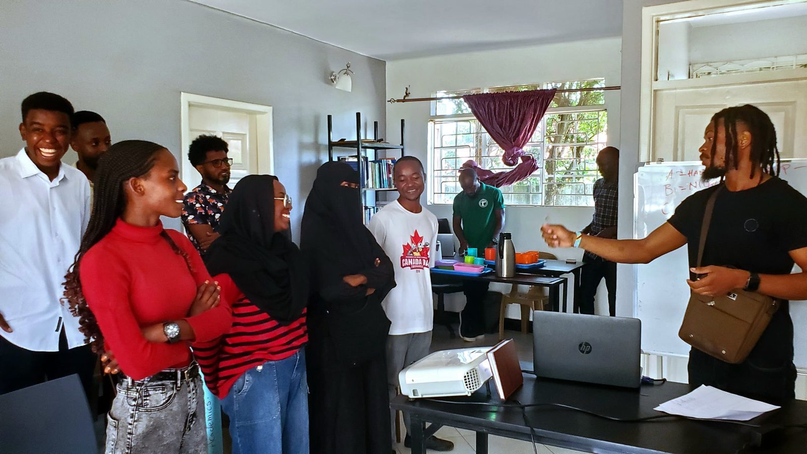 Scholars gathered around a facilitator inside the hub